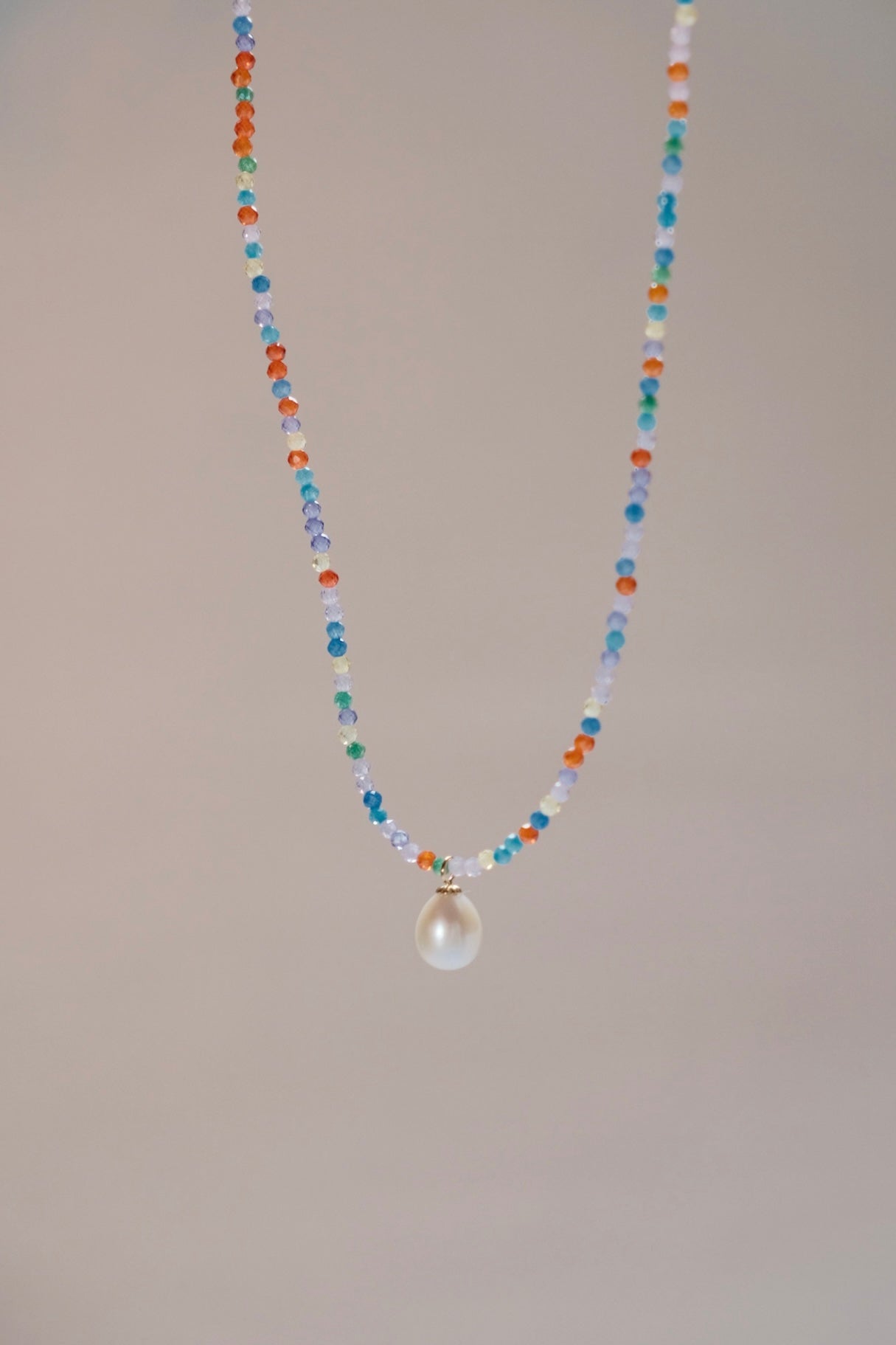 Playful combination of colorful zirconia necklace, with a single cute pearl pendants